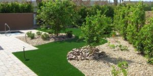 Artificial grass with trees and rocks
