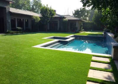 Residential artificial grass turf by a pool