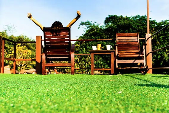 Woman relaxing on artificial grass lawn